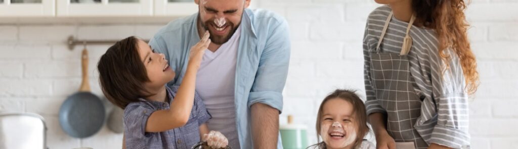 A family with young children baking together.