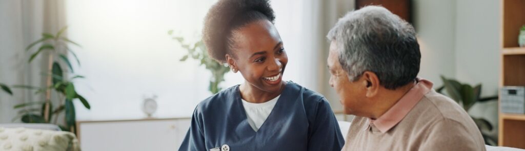 A care worker visiting a man in his home.