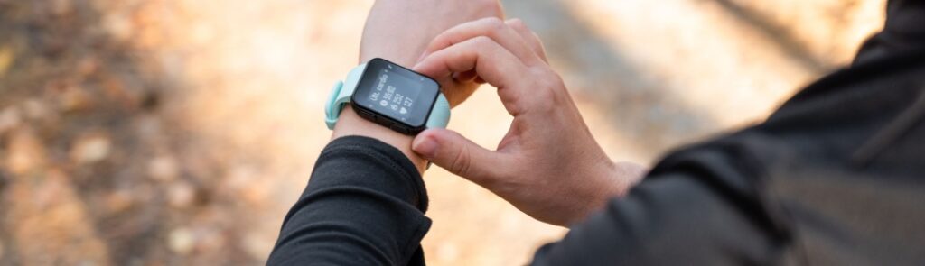 A runner looking at the time on their watch.