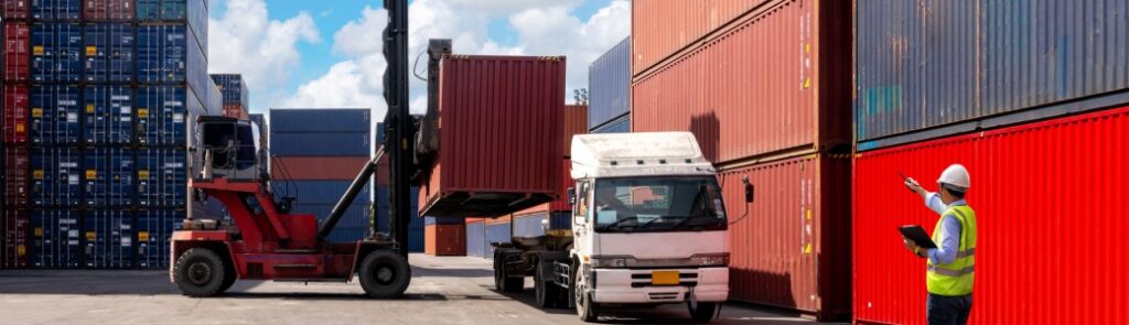 A foreman organising containers from a cargo ship.